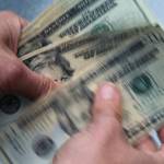 FILE- In this June 15, 2018, file photo, twenty dollar bills are counted in North Andover, Mass.  Record low-interest mortgages are long gone. Credit card rates will likely rise. You'll pay more for an auto loan. The unusually large three-quarter point hike, Wednesday, June 15, 2022 in the Fed's benchmark short-term rate is going to have a lot of impacts on Americans' finances. The hope is that by making borrowing more expensive, the Fed will succeed in cooling demand for homes, cars and other goods and services and slow inflation (AP Photo/Elise Amendola, File)