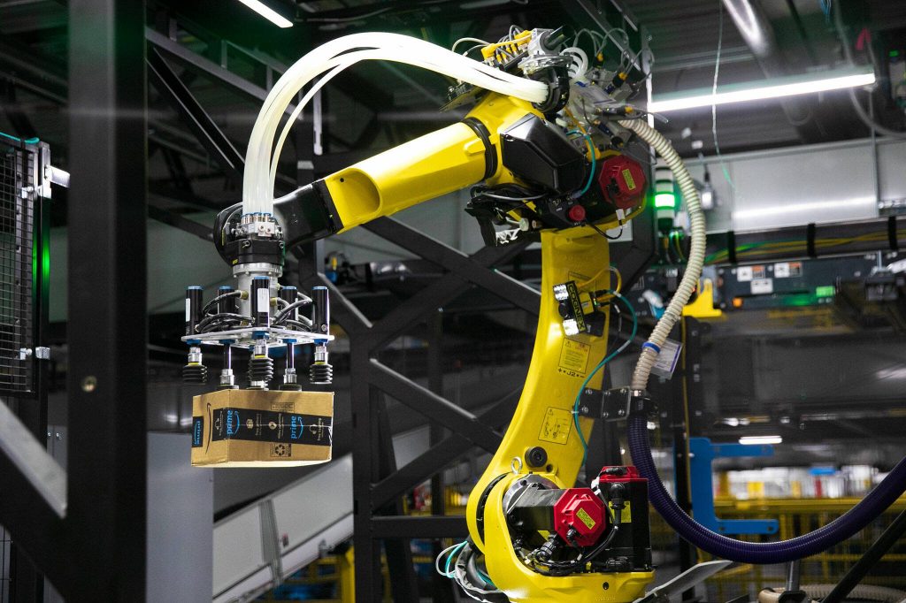 A robotic arm transfers a package at the new PAE2 Amazon Fulfillment Center on Thursday, Sept. 14, 2023, in Arlington, Washington. (Ryan Berry / The Herald)
