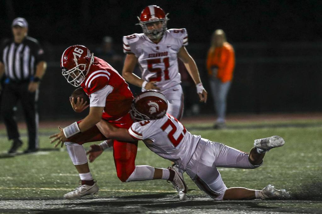 Stanwoods Ethan Burke (23) makes a tackle during a game against Marysville Pilchuck on Sept. 8 at Marysville Pilchuck High School in Marysville. (Annie Barker / The Herald)