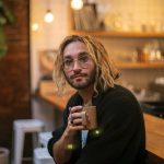 Musician Alex Johnston, whose newest album Daylight Fooldream pairs with short film he made with help from his partner, Mikaela Henderson, has his morning coffee at Narrative Coffee in Everett. (Ryan Berry / The Herald)