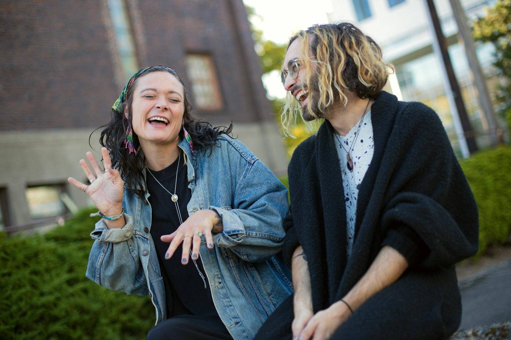 Alex Johnston and his partner, Mikaela Henderson, goof around Sept. 15 outside Narrative Coffee in Everett. (Ryan Berry / The Herald)