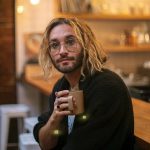 Local musician Alex Johnston, whose newest album "Daylight Fooldream" pairs with short film he made with help from his partner Mikaela Henderson, sits with his morning coffee on Friday, Sept. 15, 2023, at Narrative Coffee in Everett, Washington. (Ryan Berry / The Herald)