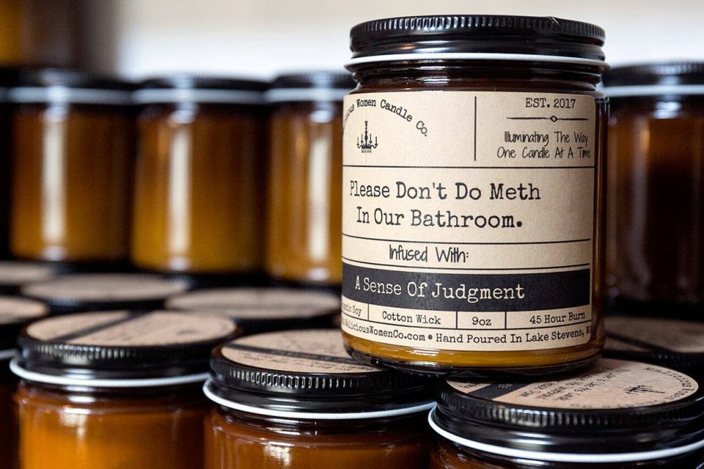 Lacie Marsh-Carrolls Malicious Women Candle are hand labeled and personalized at her home in Lake Stevens on March 17, 2018. (Kevin Clark / The Daily Herald)