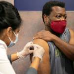 Everett resident Shon Grimes receives a flu shot from pharmacist Nisha Mathew at Bartell Drugs on Broadway on Saturday, Oct. 1, 2022, in Everett, Washington. (Ryan Berry / The Herald)