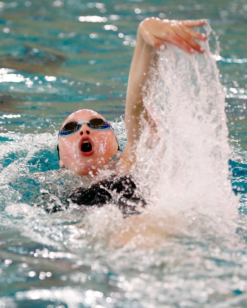 Snohomish junior Mary Clarke swims the 100 yard backstroke during an early season meet between Snohomish and Lake Stevens on Tuesday, Sept. 12, 2023, at the Snohomish Aquatic Center in Snohomish, Washington. (Ryan Berry / The Herald)
