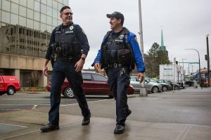 Everett Police Officer Kevin Davis, left, and Officer Mike Bernardi, right, the walk through downtown Everett on Thursday, Feb. 13, 2020. (Olivia Vanni / The Herald)