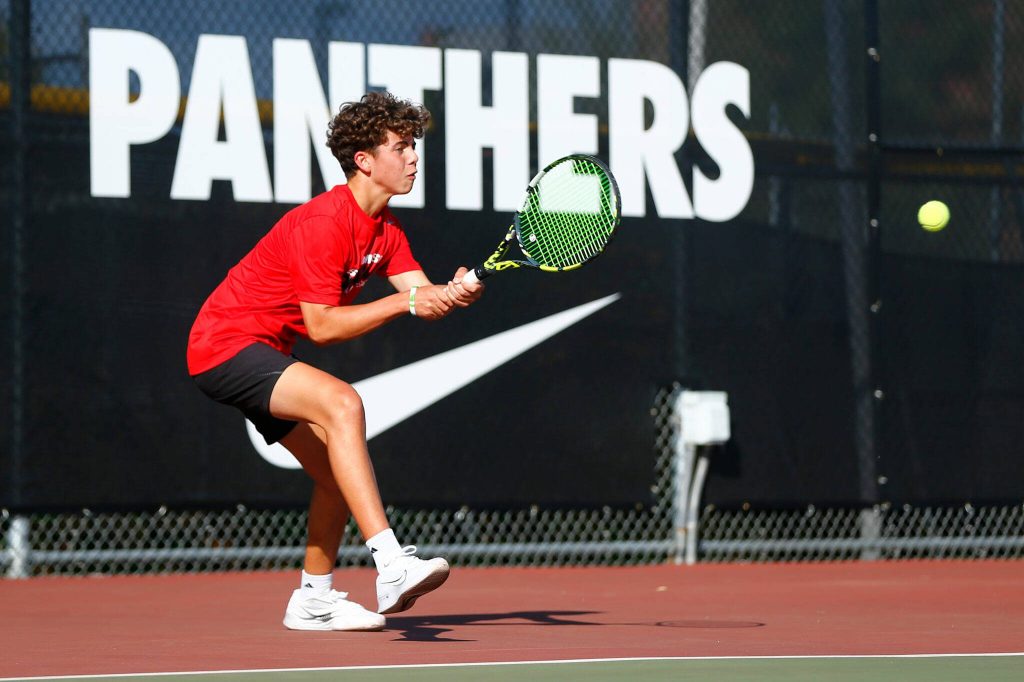 Snohomishs Cade Strickland sends a backhand back to his opponent against Edmonds-Woodway on Sept. 13 at Snohomish High School. (Ryan Berry / The Herald)