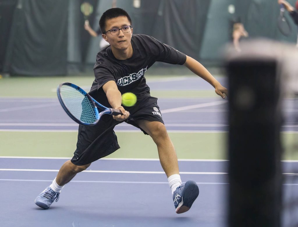 Jackson junior Henry Park reaches to hit the ball during the Class 4A District 1 doubles final on Oct. 20, 2022 in Everett. (Olivia Vanni / The Herald)