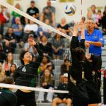 Jacksons Sakura Yokoo tips the ball over two Lynnwood blockers during a volleyball match Thursday, Sept. 14, 2023, at Lynnwood High School in Bothell, Washington. (Ryan Berry / The Herald)