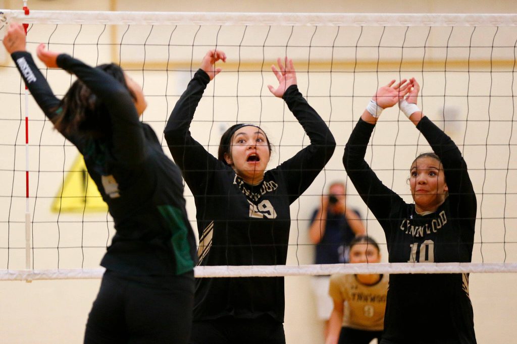 Lynnwood blockers Makena Kaleo (29) and Harmony Johnson (10) prepare for a spike from Jacksons Sakura Yokoo during a volleyball match Thursday, Sept. 14, 2023, at Lynnwood High School in Bothell, Washington. (Ryan Berry / The Herald)