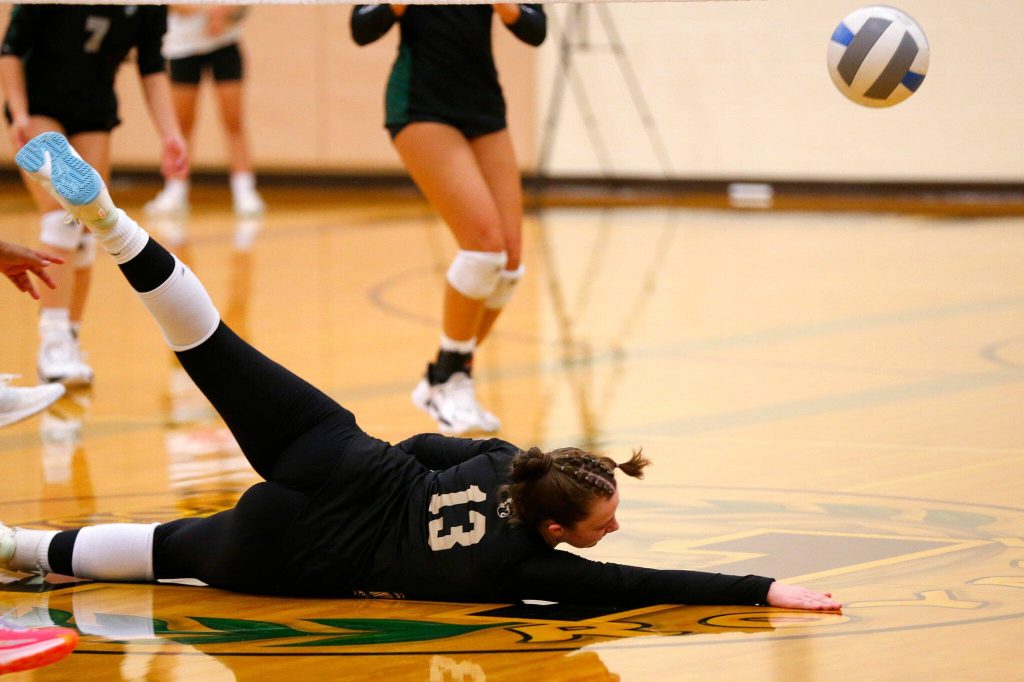 Lynnwoods Charlie Thomas nearly makes a diving save against Jackson during a volleyball match Thursday, Sept. 14, 2023, at Lynnwood High School in Bothell, Washington. (Ryan Berry / The Herald)
