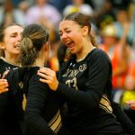 Lynnwood teammates mob senior Abbie Orr (4) after her impressive dig led to a point against Jackson during a volleyball match Thursday, Sept. 14, 2023, at Lynnwood High School in Bothell, Washington. (Ryan Berry / The Herald)