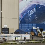 Boeing workers walk to and from their cars during a shift change on Thursday, Oct. 1, 2020 in Everett, Wa. (Olivia Vanni / The Herald)