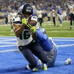 Seattle Seahawks wide receiver Tyler Lockett (16) catches a 3-yard touchdown pass in front of Detroit Lions cornerback Jerry Jacobs during the second half of an NFL football game, Sunday, Sept. 17, 2023, in Detroit. (AP Photo/Paul Sancya)