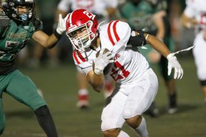 Marysville Pilchuck’s Kenai Sinaphet bruises the defense on a run against Marysville Getchell during the Berry Bowl on Friday, Sept. 15, 2023, at Quil Ceda Stadium in Marysville, Washington. (Ryan Berry / The Herald)