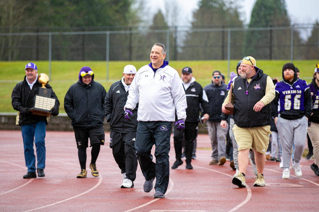 Lake Stevens football coach Tom Tri leads the team onto the field during the 4A state championship celebration on Dec. 10, 2022, in Lake Stevens. (Ryan Berry / The Herald)