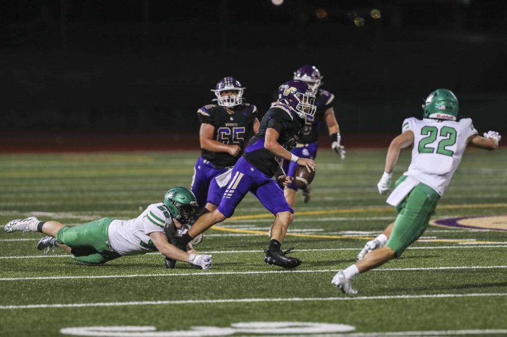 Lake Stevens Kolton Matson (12) runs with the ball during a game against West Linn at Lake Stevens High School on Friday. (Annie Barker / The Herald)