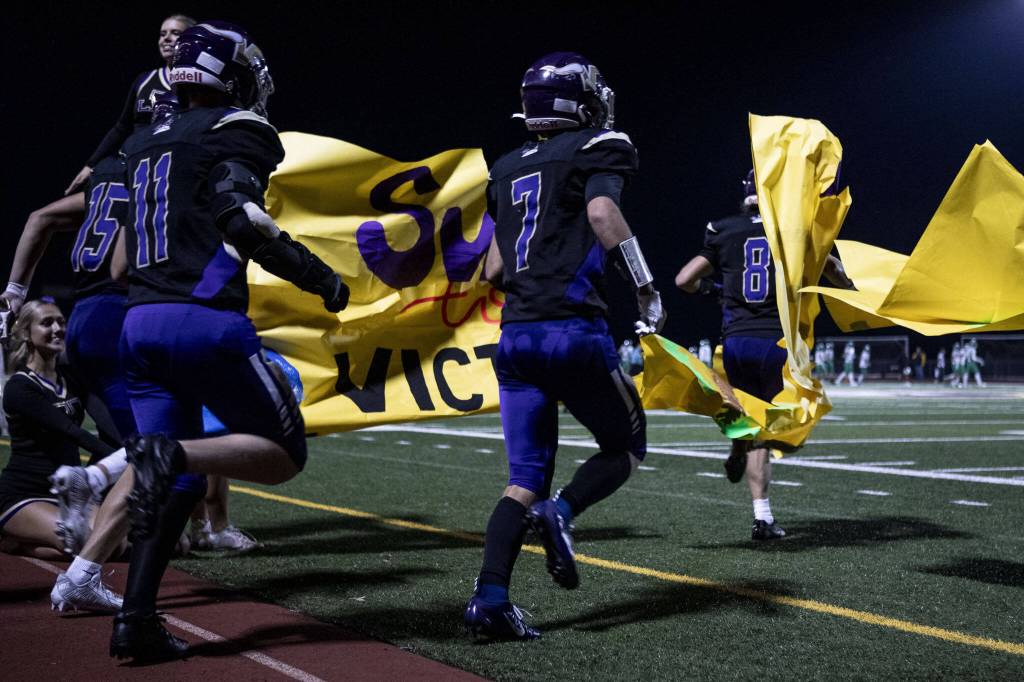 Lake Stevens players run onto the field during a football game between Lake Stevens and West Linn at Lake Stevens High School in Lake Stevens, Washington on Friday, Sept. 22, 2023. West Linn won, 49-30. (Annie Barker / The Herald)