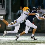 Arlington junior wideout Kaid Hunter reaches out and makes a basket catch on a deep ball against Ferndale on Friday, Sept. 22, 2023, at Arlington High School in Arlington, Washington. (Ryan Berry / The Herald)