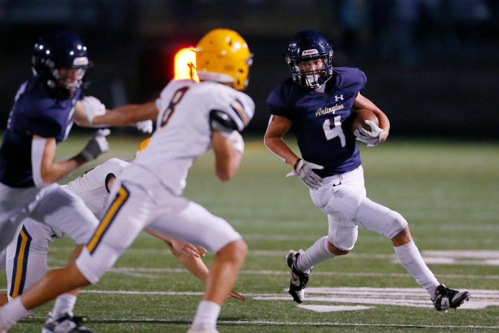 Arlingtons Jake Willis covers a lot of ground on a punt return against Ferndale on Friday, Sept. 22, 2023, at Arlington High School in Arlington, Washington. (Ryan Berry / The Herald)