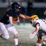 Arlingtons Caleb Reed tries to evade a defender against Ferndale on Friday, Sept. 22, 2023, at Arlington High School in Arlington, Washington. (Ryan Berry / The Herald)