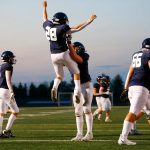 Arlingtons Caleb Reed is thrown into the air by lineman Dylan Scott after scoring a touchdown against Ferndale on Friday, Sept. 22, 2023, at Arlington High School in Arlington, Washington. (Ryan Berry / The Herald)