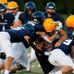 Arlingtons defense stuffs Ferndale running back Talan Bungard on Friday, Sept. 22, 2023, at Arlington High School in Arlington, Washington. (Ryan Berry / The Herald)