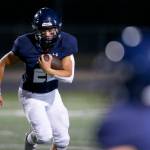 Arlington running back Caleb Reed looks for space against Ferndale on Friday, Sept. 22, 2023, at Arlington High School in Arlington, Washington. (Ryan Berry / The Herald)