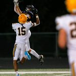 Arlington junior Jake Willis comes down with a leaping catch before taking it in for a touchdown against Ferndale on Friday, Sept. 22, 2023, at Arlington High School in Arlington, Washington. (Ryan Berry / The Herald)