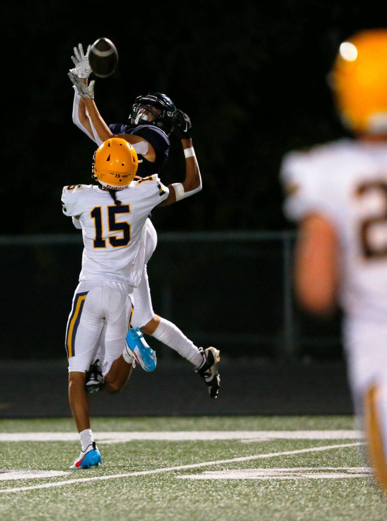 Arlington junior Jake Willis comes down with a leaping catch before taking it in for a touchdown against Ferndale on Friday, Sept. 22, 2023, at Arlington High School in Arlington, Washington. (Ryan Berry / The Herald)