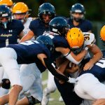Arlington’s defense stuffs Ferndale running back Talan Bungard on Friday, Sept. 22, 2023, at Arlington High School in Arlington, Washington. (Ryan Berry / The Herald)