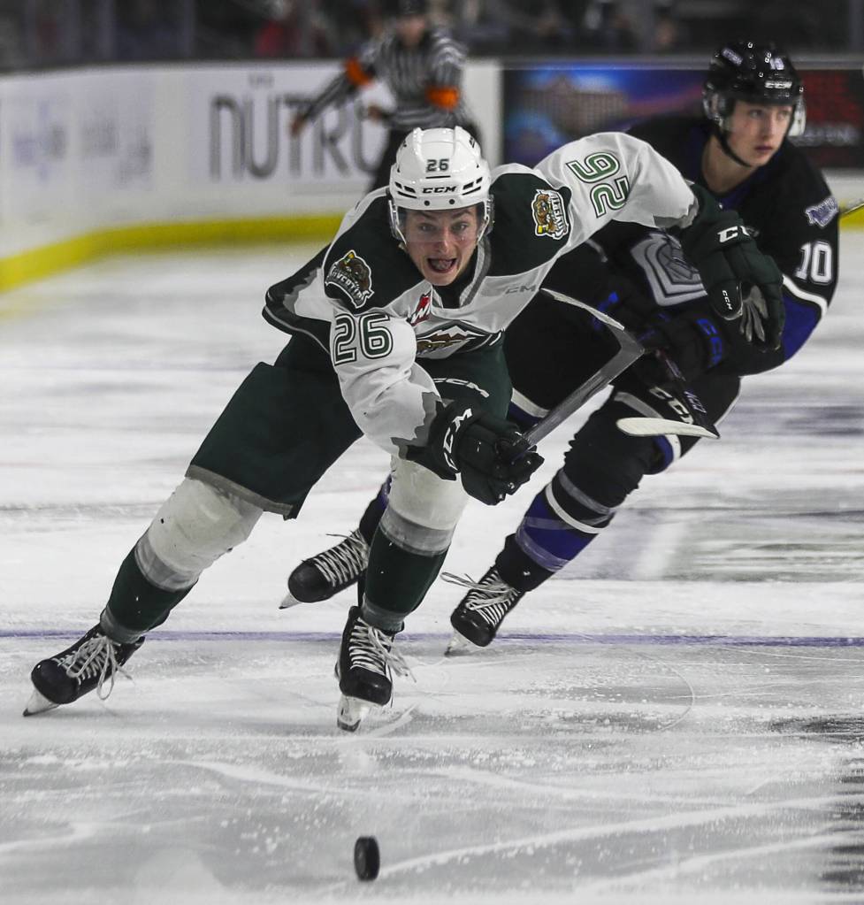 Annie Barker / The Herald
The Silvertips Andrew Petruk (26) fights for the puck during a game against the Royals on Saturday at the Angel of the Winds Arena.