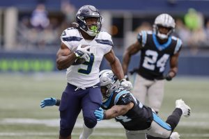 Seattle Seahawks running back Kenneth Walker III is tackled by Carolina Panthers linebacker Kamu Grugier-Hill during the first half of an NFL football game Sunday, Sept. 24, 2023, in Seattle. (AP Photo/John Froschauer)