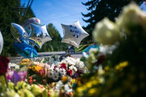 A memorial for a 15-year-old shot and killed last week is set up at a bus stop along Harrison Road on Wednesday, Sept. 13, 2023, in Everett, Washington. (Ryan Berry / The Herald)