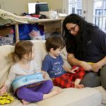 Patricia Gambis talks with her then 4-year-old twin children, Emma (left) and Etienne in their home, in January 2019, in Maplewood, N.J. Gambis husband, an FBI agent, had been working without pay during the partial United States government shutdown, which forced the couple to take financial decisions including laying off their babysitter. (Julio Cortez / Associated Press)