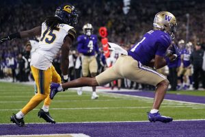 Washington wide receiver Rome Odunze (1) scores a touchdown next to California defensive back Lu-Magia Hearns III (15) during the first half of an NCAA college football game Saturday, Sept. 23, 2023, in Seattle. (AP Photo/Lindsey Wasson)