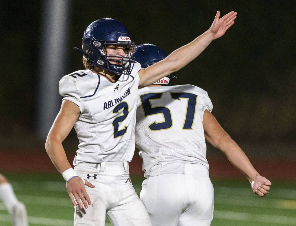 Arlingtons Chase Deberry point to signal for a turnover during the game against Stanwood on Friday, Sept. 29, 2023 in Stanwood, Washington. (Olivia Vanni / The Herald)