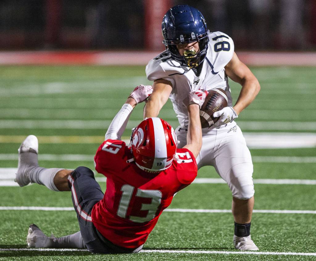 Arlingtons Stevie Balderas escapes a tackle by Stanwoods Cole Williams during the game on Friday, Sept. 29, 2023 in Stanwood, Washington. (Olivia Vanni / The Herald)