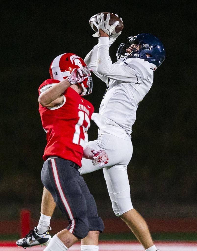Arlingtons Jake Willis leaps above Stanwoods Cole Williams to make a catch during the game on Friday, Sept. 29, 2023 in Stanwood, Washington. (Olivia Vanni / The Herald)