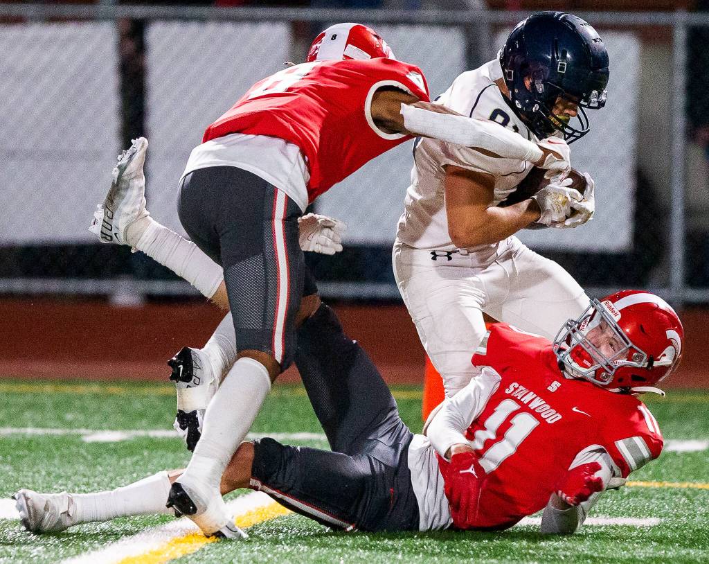 Arlingtons Stevie Balderas runs through multiple tackles by Stanwood players during the game on Friday, Sept. 29, 2023 in Stanwood, Washington. (Olivia Vanni / The Herald)