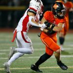 Monroe captain Gavin Ranz fights for extra yards on a handoff against Mountlake Terrace on Friday, Sept. 29, 2023, at Monroe High School in Monroe, Washington. (Ryan Berry / The Herald)