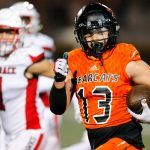 Monroe junior receiver Aaron Clifton checks for defenders while taking a long reception to the house against Mountlake Terrace on Friday, Sept. 29, 2023, at Monroe High School in Monroe, Washington. (Ryan Berry / The Herald)