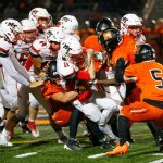 Mountlake Terrace quarterback Matthew Meadows is pulled to the ground by the Monroe defense on a quarterback keeper on Friday, Sept. 29, 2023, at Monroe High School in Monroe, Washington. (Ryan Berry / The Herald)