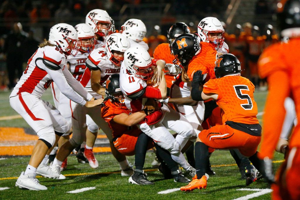 Mountlake Terrace quarterback Matthew Meadows is pulled to the ground by the Monroe defense on a quarterback keeper on Friday, Sept. 29, 2023, at Monroe High School in Monroe, Washington. (Ryan Berry / The Herald)