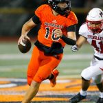Monroes Blake Springer rolls out of the pocket before firing downfield against Mountlake Terrace on Friday, Sept. 29, 2023, at Monroe High School in Monroe, Washington. (Ryan Berry / The Herald)