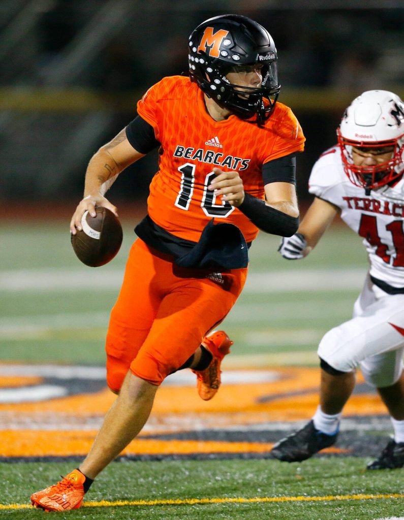 Monroes Blake Springer rolls out of the pocket before firing downfield against Mountlake Terrace on Friday, Sept. 29, 2023, at Monroe High School in Monroe, Washington. (Ryan Berry / The Herald)