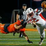 Mountlake Terrace’s Zaveon Jones is pulled to the ground by a diving Nicholas Mouser of Monroe on Friday, Sept. 29, 2023, at Monroe High School in Monroe, Washington. (Ryan Berry / The Herald)