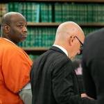 Antonial Monroe, left, alongside defense attorney Donald Wackerman, center, looks over at prosecuting attorney Matt Hunter as Hunter addresses the court during Monroes sentencing hearing Thursday, Oct. 5, 2023, at Snohomish County Superior Court in Everett, Washington. (Ryan Berry / The Herald)