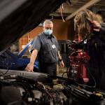 Richie del Puerto watches as a student works to jump start a car during class at Sno-Isle Technical Skills Center on Tuesday, Nov. 2, 2021 in Everett, Washington. (Olivia Vanni / The Herald)