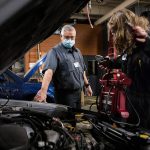 Richie del Puerto watches as a student works to jump start a car during class at Sno-Isle Technical Skills Center on Tuesday, Nov. 2, 2021 in Everett. (Olivia Vanni / The Herald)